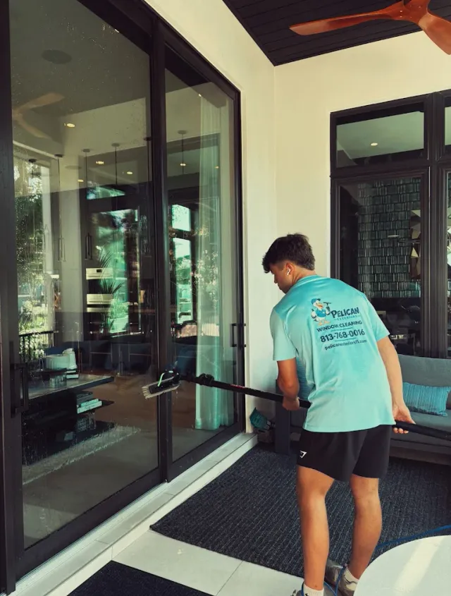 Pure water running down the glass from a water-fed brush at a Tampa waterfront home