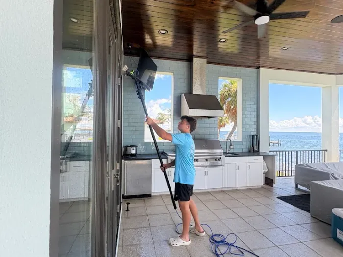 Cleaning sliding glass doors on a waterfront lanai overlooking Tampa Bay