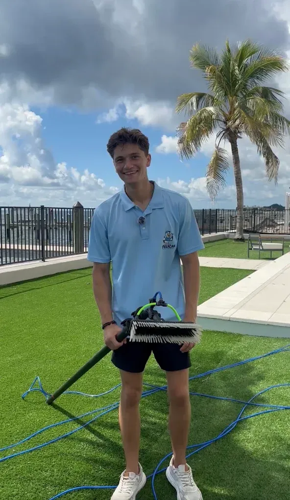 Gavin Meltcher of Pelican Exteriors with the water-fed brush at a waterfront Tampa property