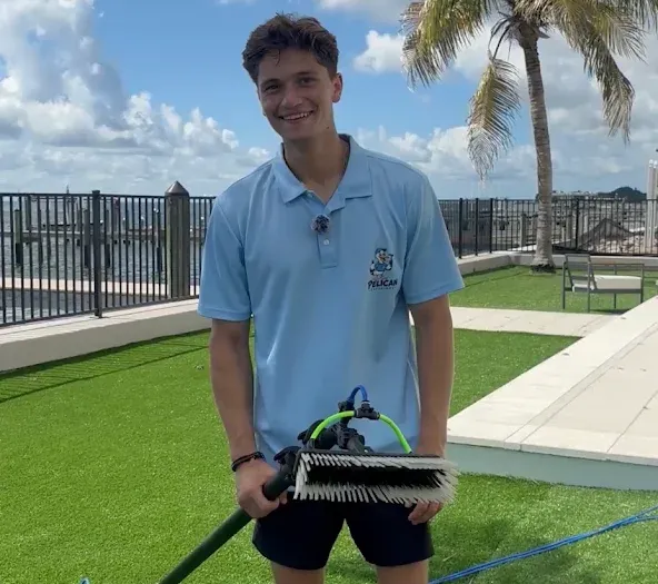 Gavin Meltcher of Pelican Exteriors with the water-fed brush at a waterfront Tampa property