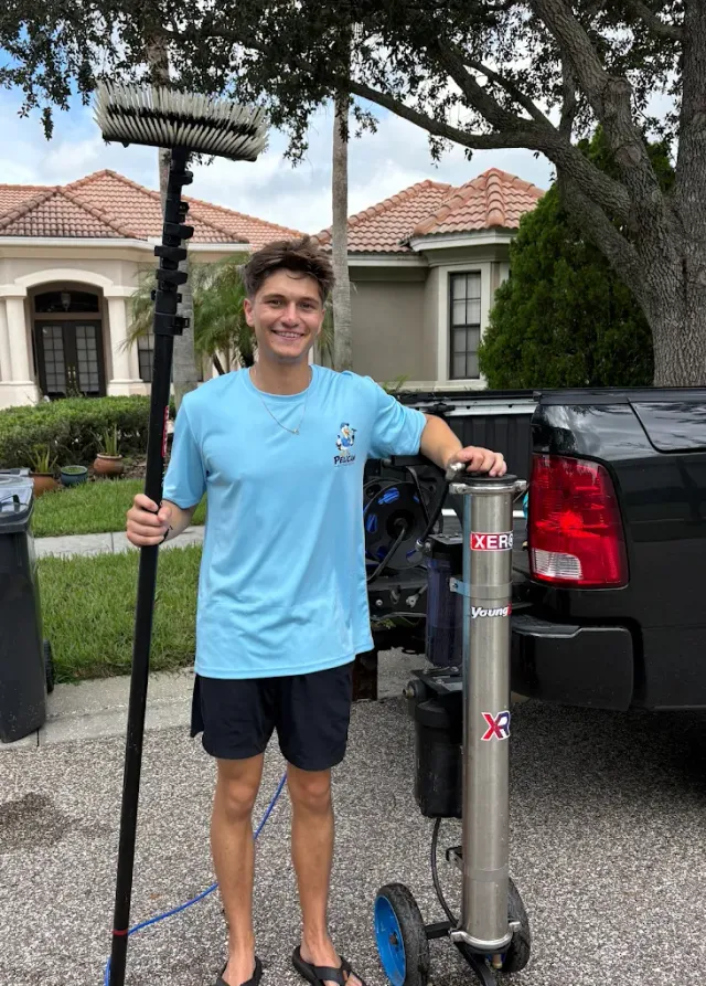 Gavin Meltcher of Pelican Exteriors with the water-fed pole and pure-water cart at a Tampa property