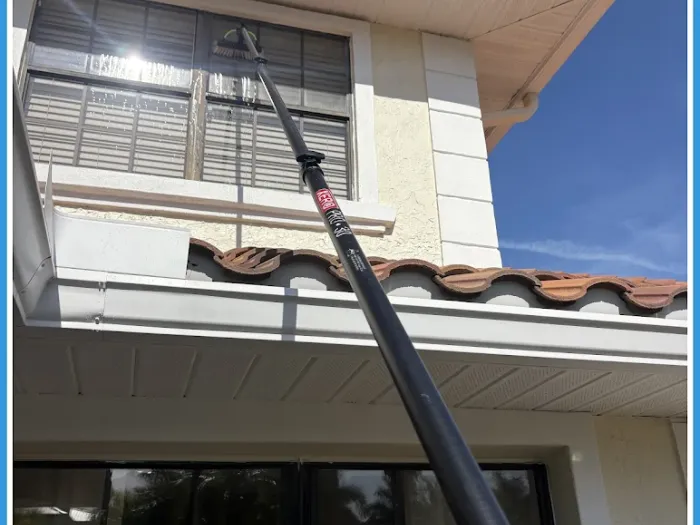Pure-water pole cleaning upper windows above a lanai in Tampa