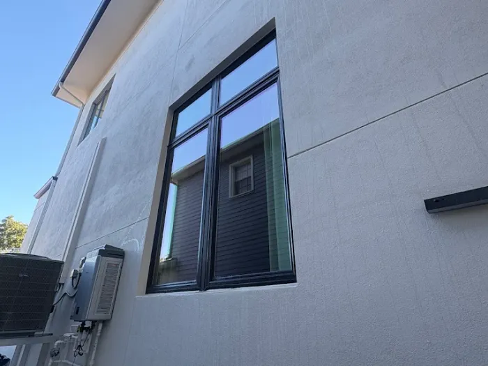 Exterior window cleaning on a white stucco Tampa home